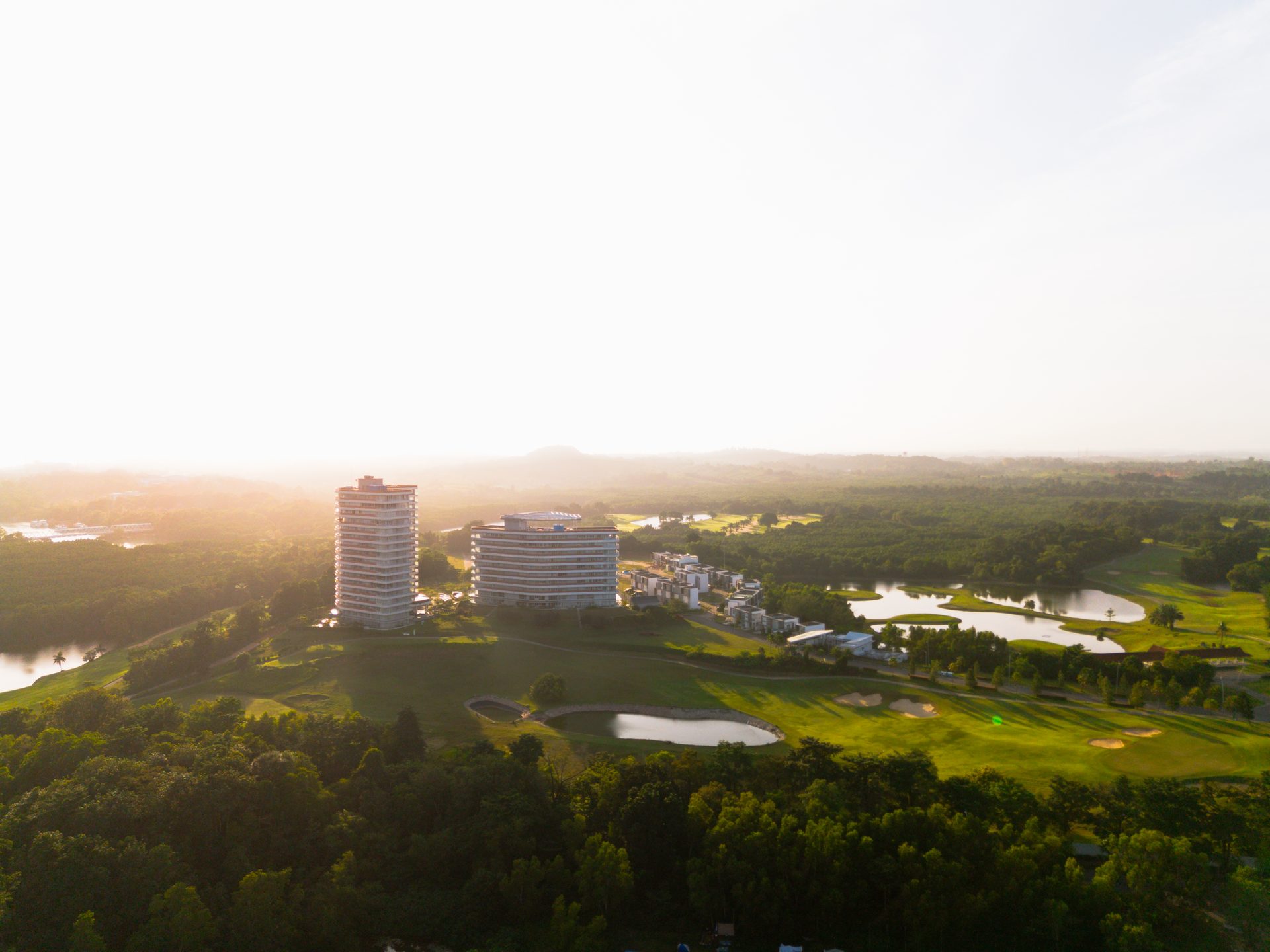 Aerial view of Kalani Tower and Palm Springs golf resort in Batam at sunrise