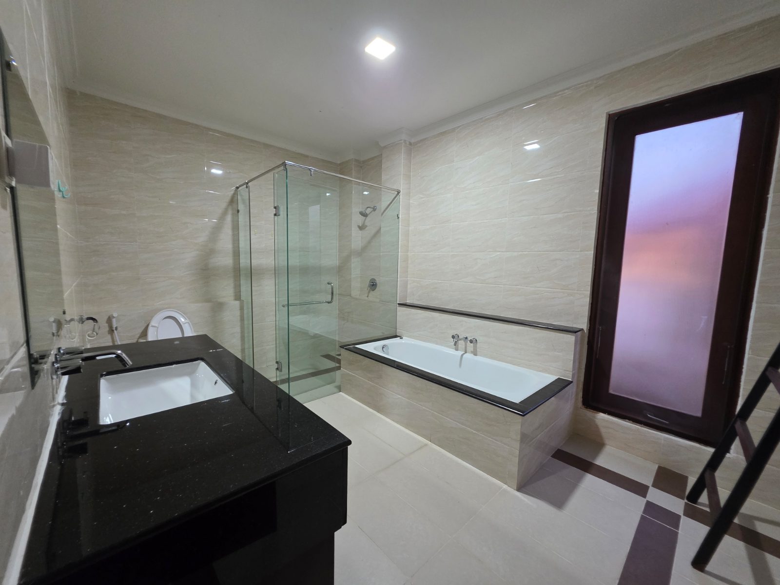 Villa Panbil Batam bathroom with bathtub and glass shower