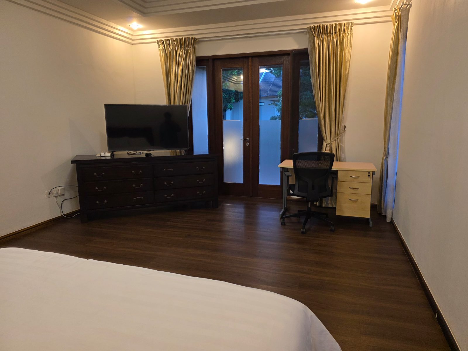 Villa Panbil Batam master bedroom with TV and desk
